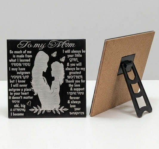 Mother and daughter laser engraved ceramic tile with heartfelt wording and butterflies, shown alongside its cork backing and black plastic stand.