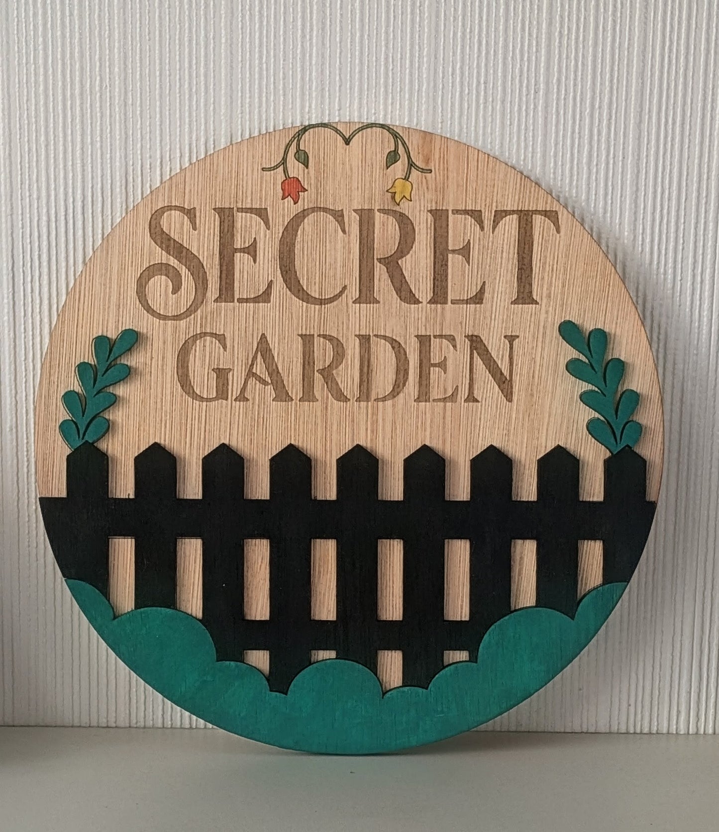 Personalised round wooden garden sign – Secret Garden example