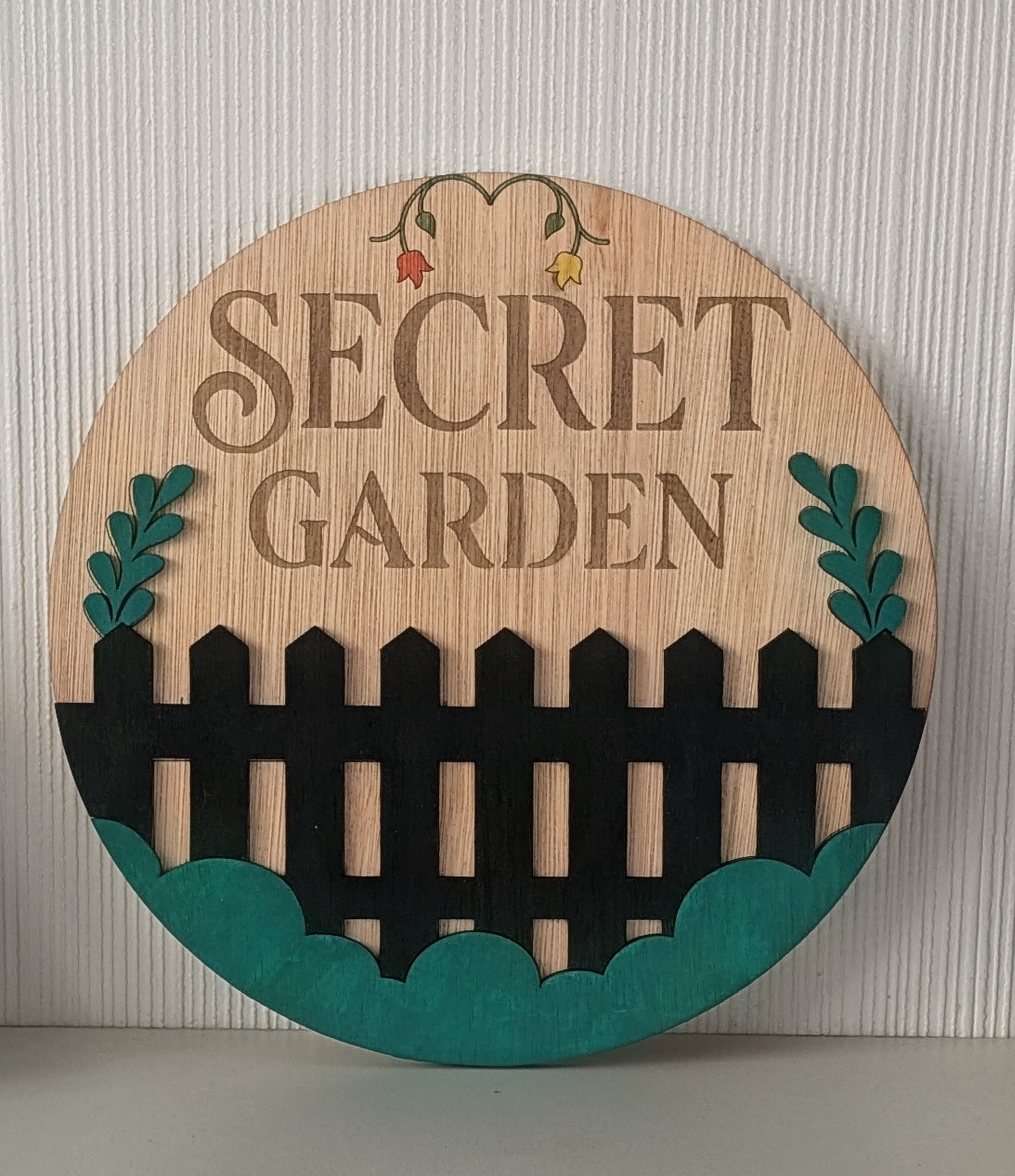 Personalised round wooden garden sign – Secret Garden example